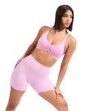 ORU HALTER SPORTS BRA pink nylon spandex blend with sweetheart neckline and adjustable back strap on female model