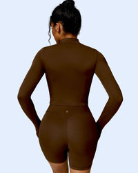 Woman wearing brown ORU MIKA Jacket with V-Shaped Back Design, breathable and quick-dry fabric for gym and yoga