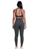 Woman wearing black ORU LEGACY leggings with ultra high rise and butterfly three-seam back waistband detail from the rear view