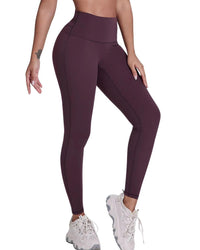 Women wearing ultra high rise ORU Legacy Leggings in dark purple with butterfly 3-seam back waistband detail and white sneakers