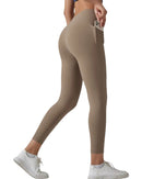 Woman wearing high-waisted beige Oru soft pocket leggings with a phone in side pocket and white sneakers
