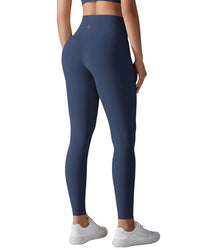 Woman wearing navy blue ORU Everyday Leggings with high-waist compression band and seamless design