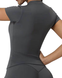 Back view of woman wearing a dark gray ORU fitted top with a round neckline, slim fit design, and short sleeves made from lightweight, breathable, quick-dry fabric