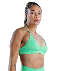 Green Back view of a woman wearing a navy seamless ORU SPARK SPORTS BRA with strappy back and light support underband.Back view of a woman wearing a navy seamless ORU SPARK SPORTS BRA with strappy back and light support underband.Spark Sports Bra with seamless design and strappy back.