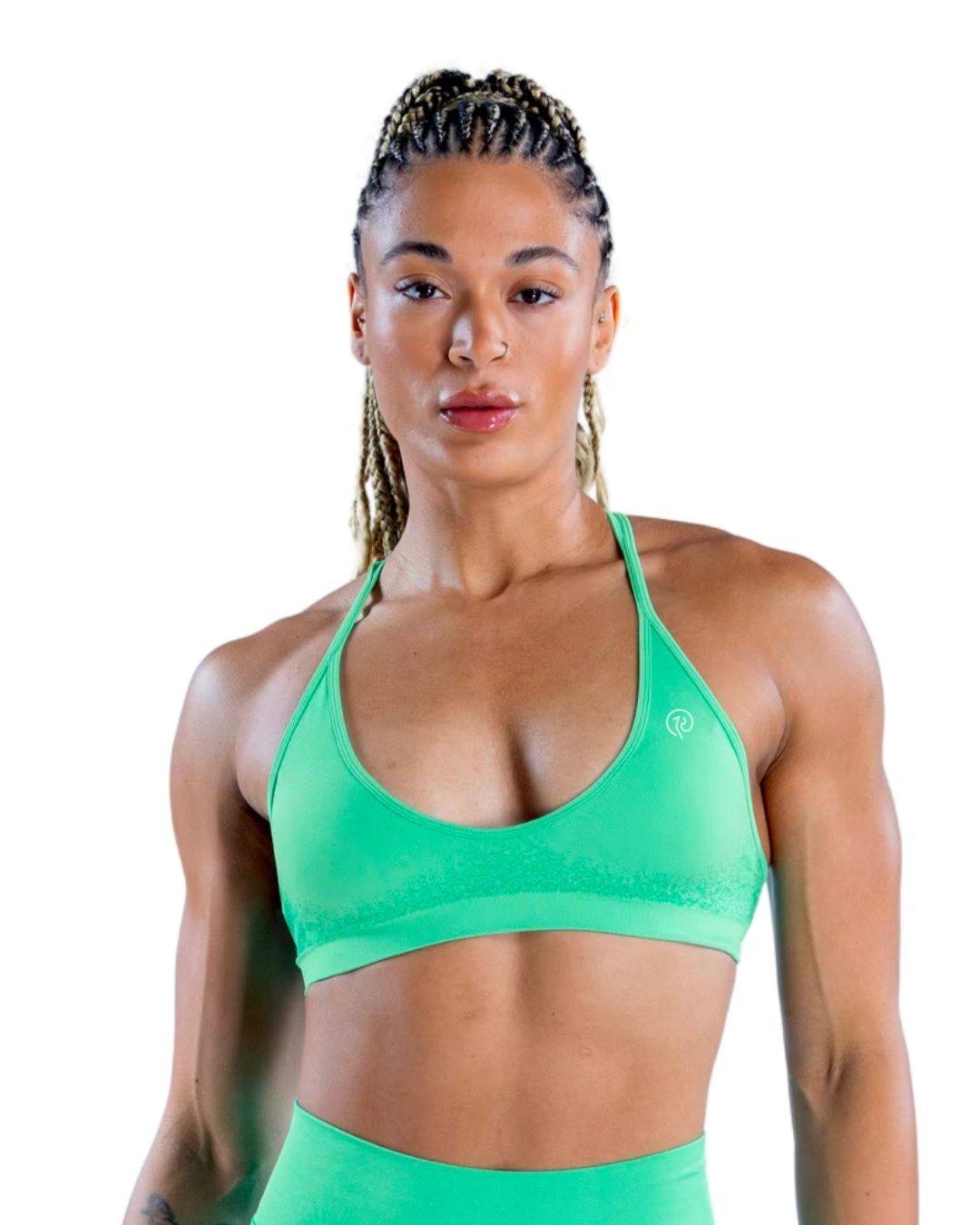 Back view of a woman wearing a navy seamless ORU SPARK SPORTS BRA with strappy back and light support underband.