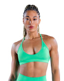 Back view of a woman wearing a navy seamless ORU SPARK SPORTS BRA with strappy back and light support underband.