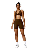 Woman wearing brown ORU MIKA SHORTs with V-shaped back design, breathable and quick-dry fabric, ideal for gym and yoga.